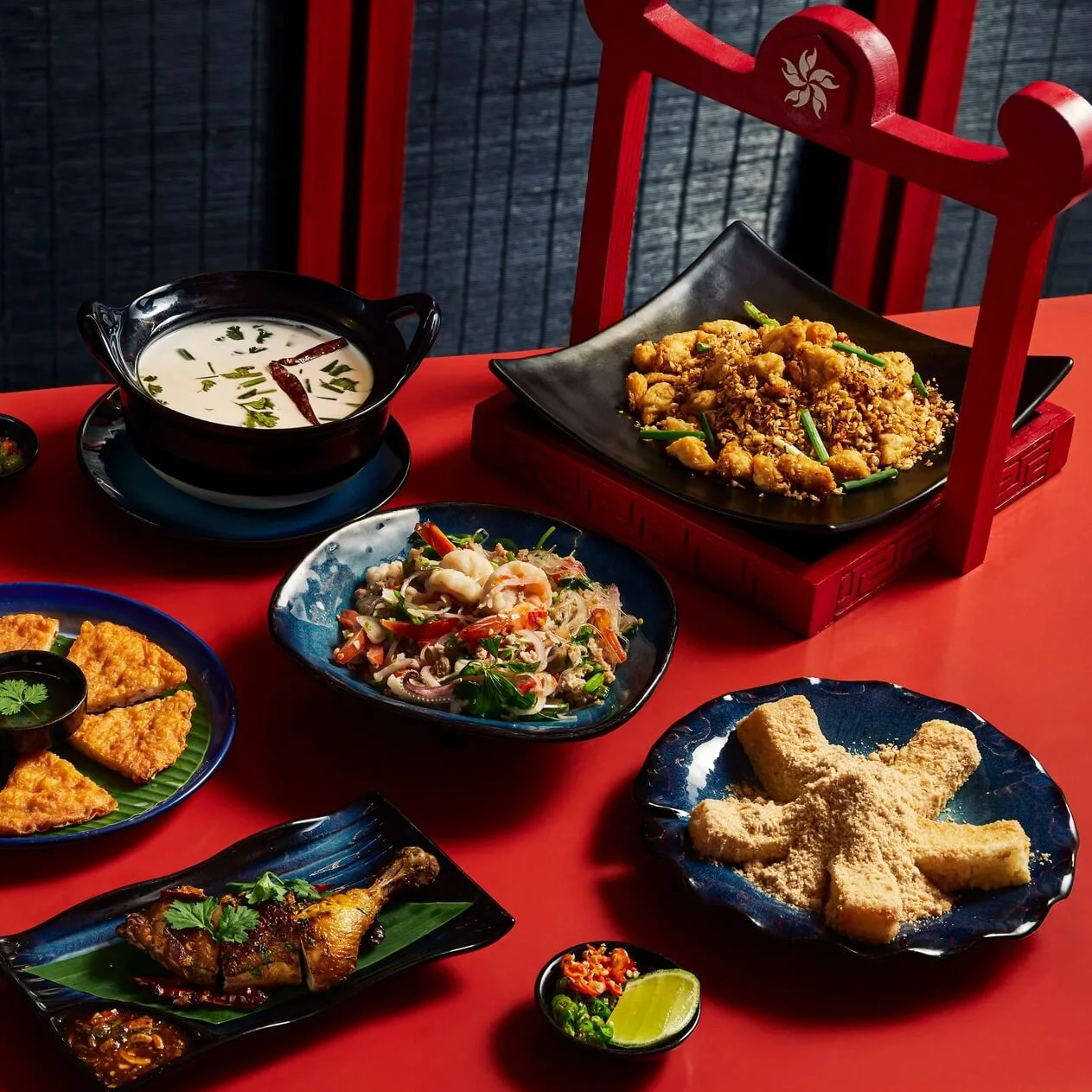 Premium Thai tasting set featuring Tom Kha soup and crispy chili-garlic seafood