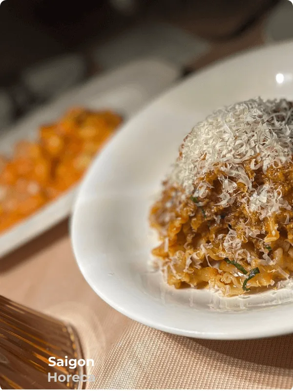 Mafaldine Bolognese pasta crowned with grated aged cheese at Bambino