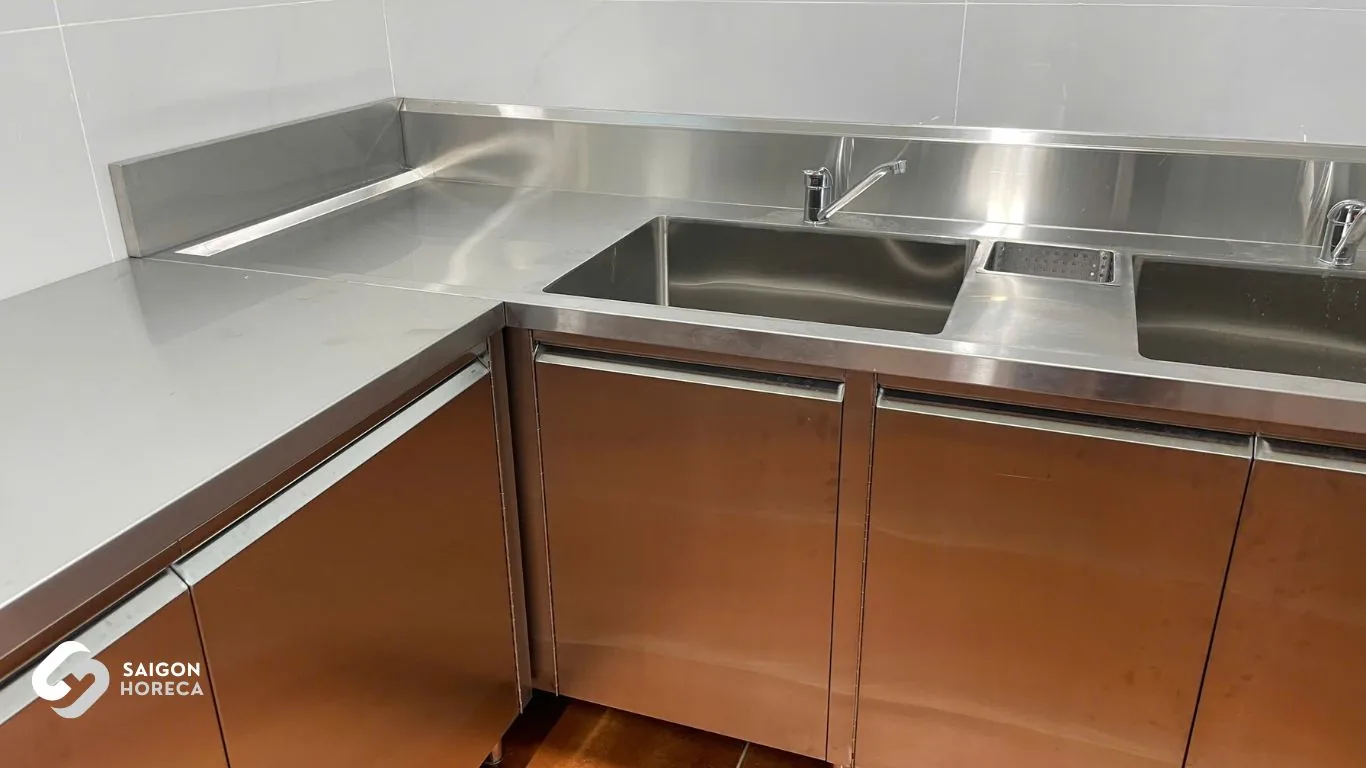 L-shaped stainless steel prep sink counter with integrated base cabinets in Vinh Hiep prep station