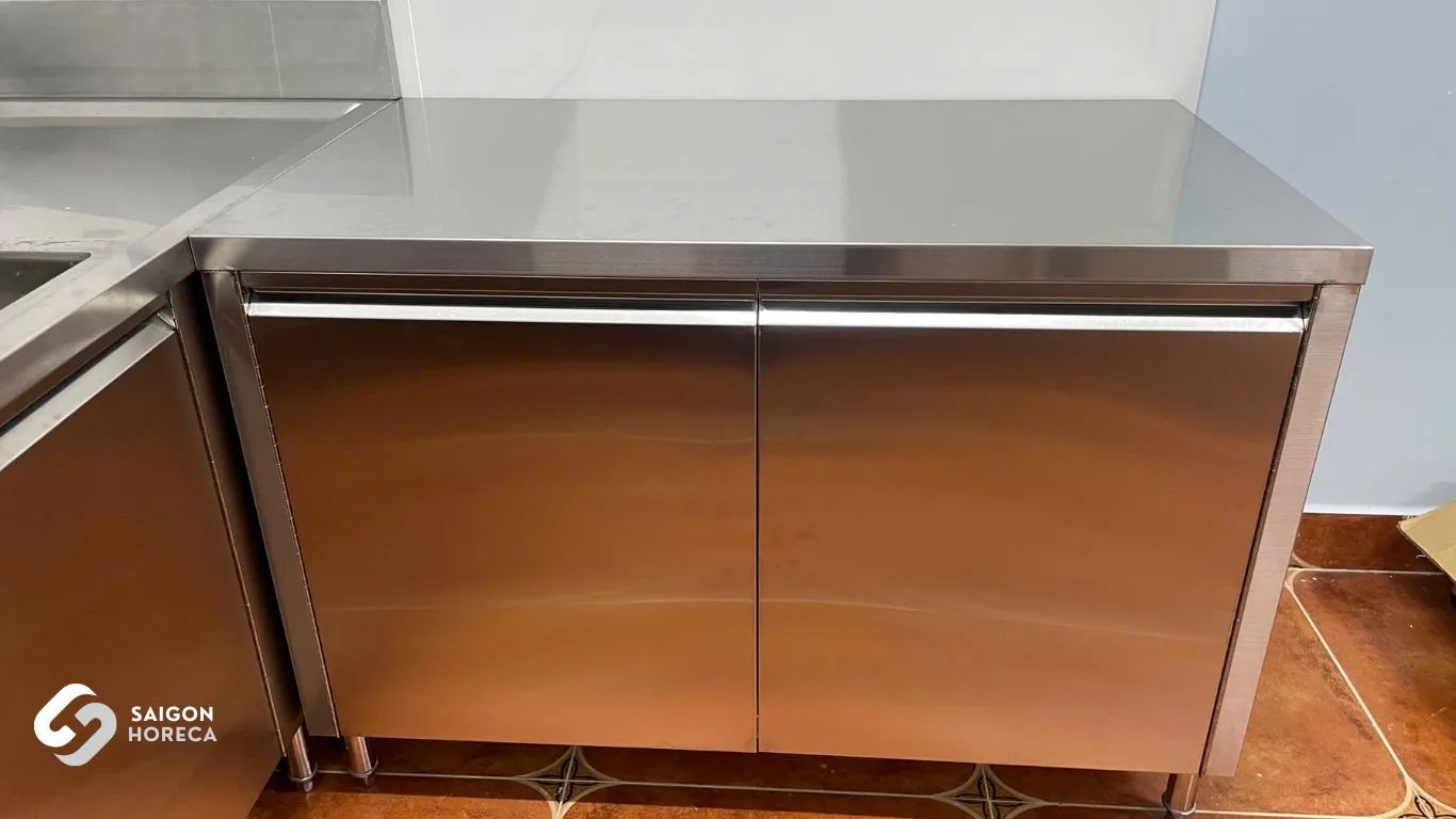 Custom two-door undercounter stainless steel storage cabinet on heavy-duty legs at Vinh Hiep kitchen fabricated by Saigon Horeca