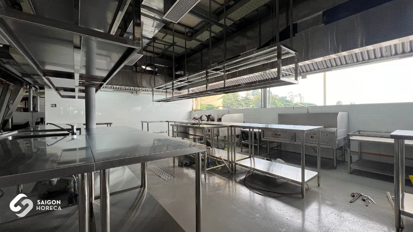 Stainless steel commercial kitchen system with prep tables and exhaust hood installed by Saigon Horeca at Ganh Hao