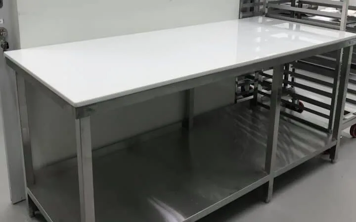 Heavy-duty stainless steel inspection and packaging worktable at Grand Marble