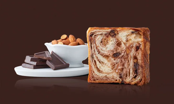 Slice of 64-layer Danish Marble bread interlacing toasted almonds and dark chocolate