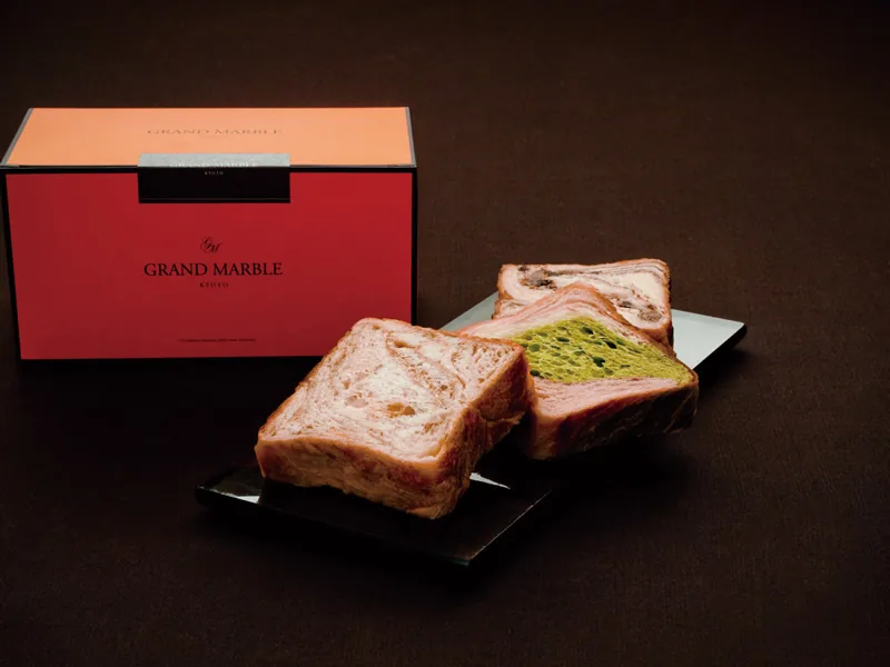 Iconic Grand Marble orange gift box paired with sliced original and matcha marble Danish pastries on slate tableware