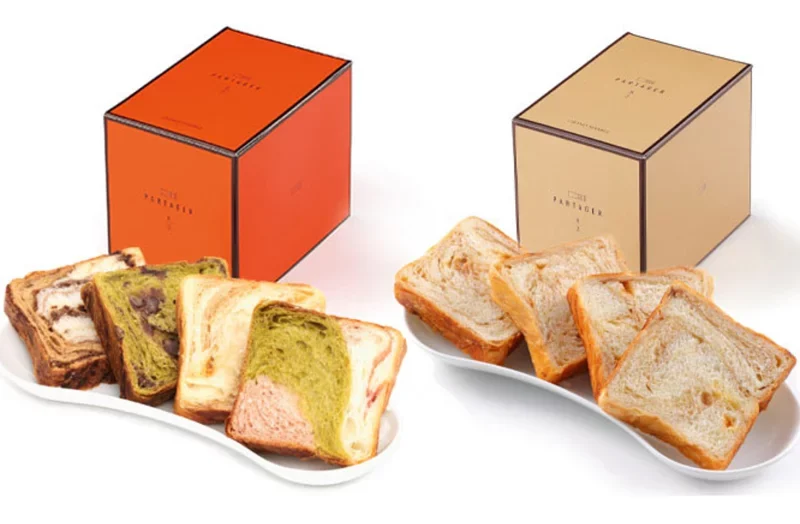 Sliced Danish Marble assortments showcased alongside Grand Marble's signature orange and champagne gift boxes
