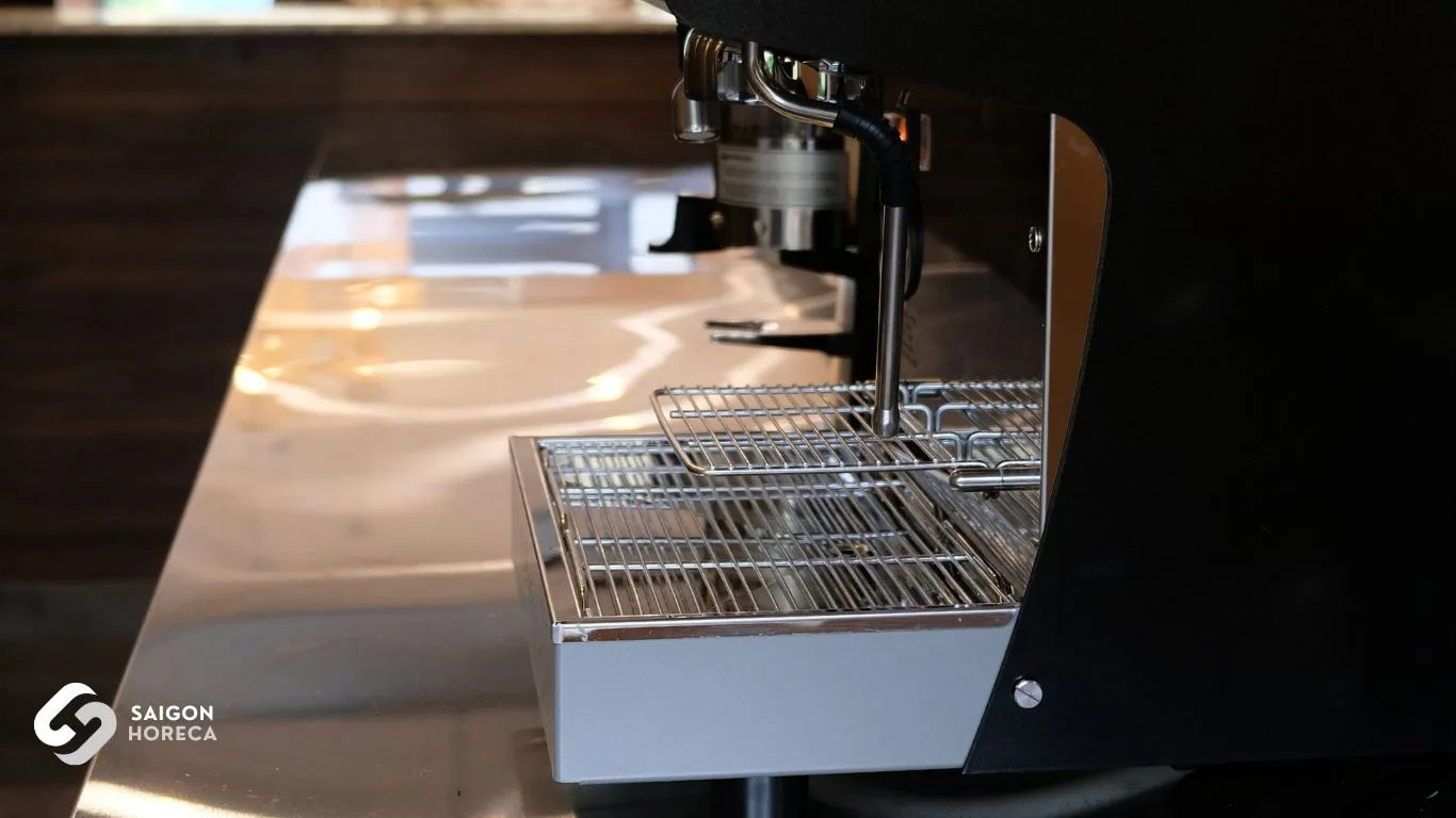 Close-up of the stainless steel drip tray grating flush-set into the prep counter—showcasing precision laser-cut fabrication.