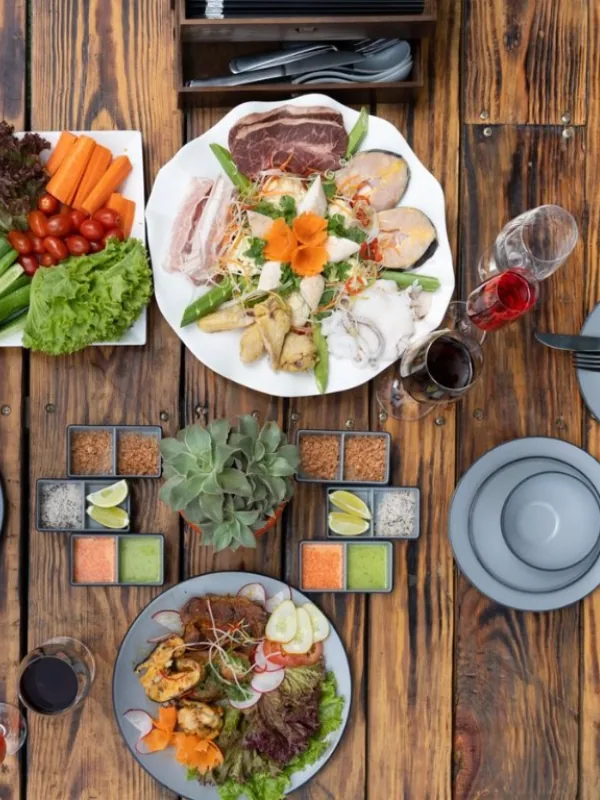 Gourmet dishes elegantly presented on a natural wooden dining table