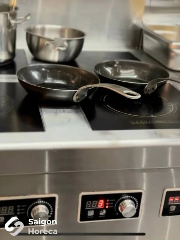 Detail of precision stainless steel craftsmanship and high-end cooking equipment at Little Bear