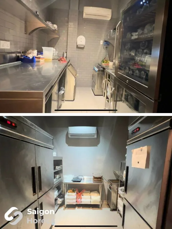 Stainless steel back-of-house staging zone with prep tables, glass-door display cabinets, and reach-in upright chillers at Little Bear