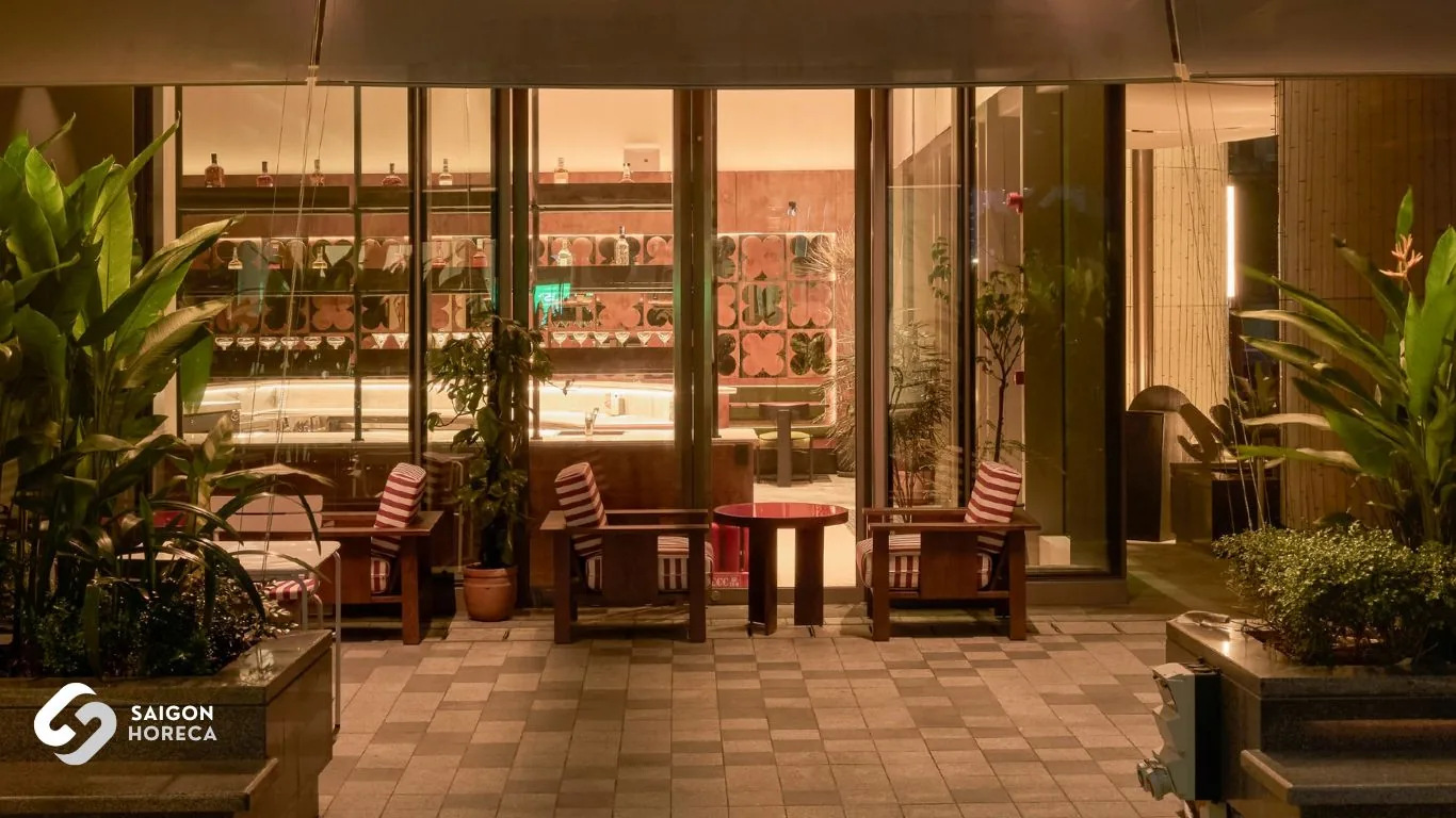 Mam Mam lounge area with plush armchairs overlooking the artfully curved stainless steel bar