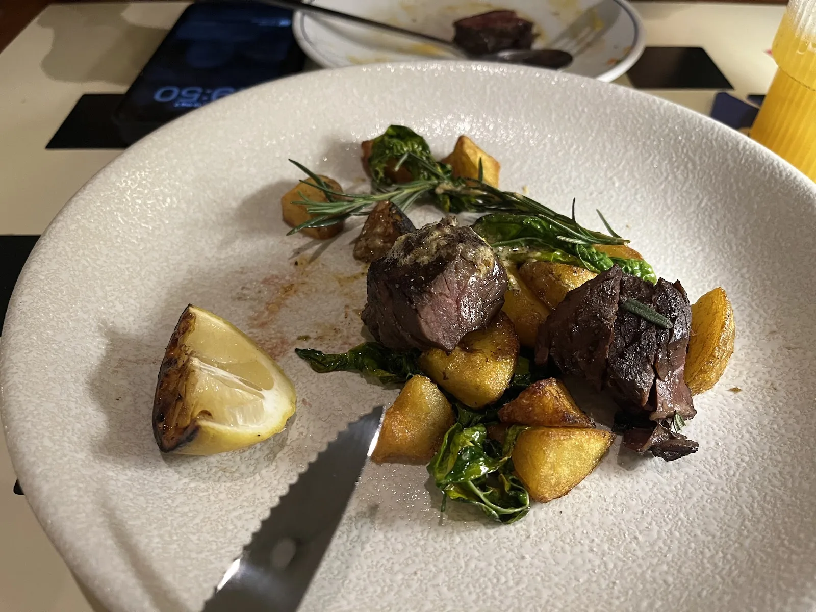 Pan-seared beef steak with crispy fries and fresh rosemary at Moa Moa