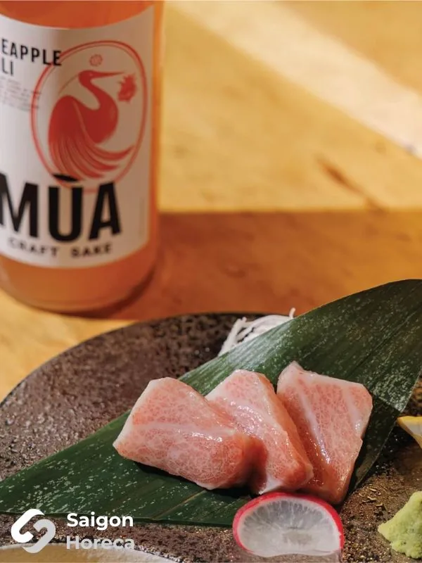 Fatty tuna sashimi paired with a bottle of Mùa Craft Sake