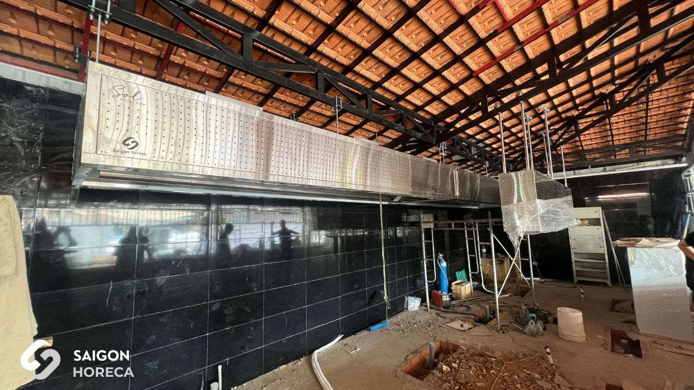 8-meter stainless steel exhaust hood system for main cooking line during on-site installation at Sol Kitchen & Bar District 7.