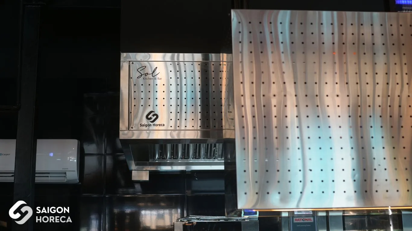 Completed heavy-duty stainless steel exhaust hood custom laser-engraved with Sol Kitchen & Bar logo at the District 7 commercial kitchen.
