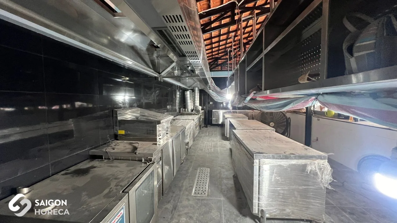 Installation of protective film-wrapped commercial stainless steel kitchen equipment on-site at Sol Kitchen & Bar District 7.