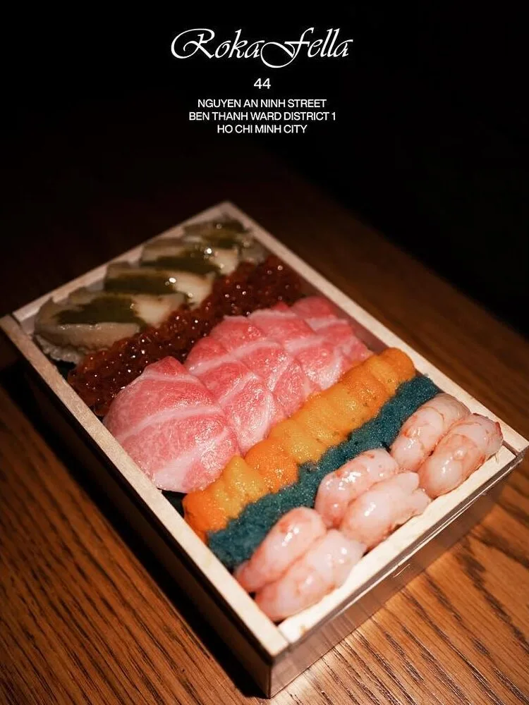 Handcrafted wooden box presenting Otoro, Ikura, and sweet shrimp nigiri at Roka Fella.