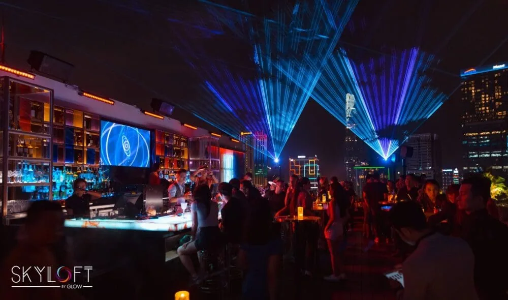 Panoramic nocturnal view of Skyloft by Glow rooftop venue electrified by laser light displays.