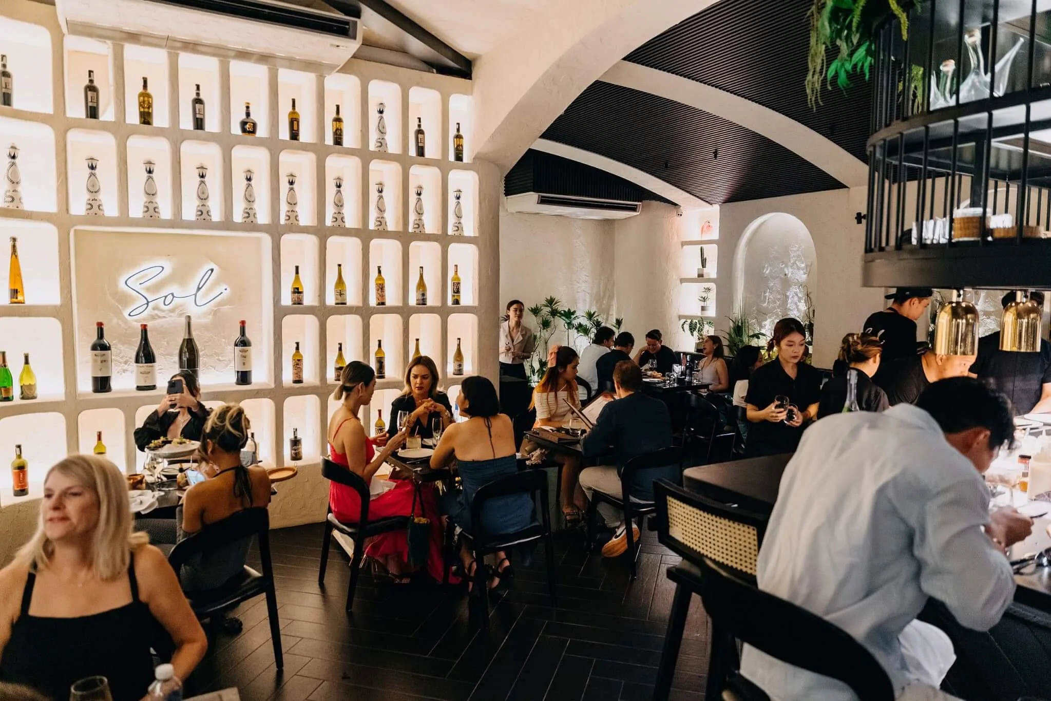 Panoramic view of the wine display dining hall at Sol Kitchen & Bar