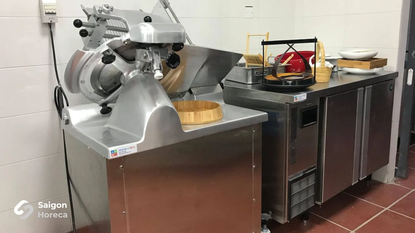Commercial meat slicer and heavy-duty chest freezer in meat prep area