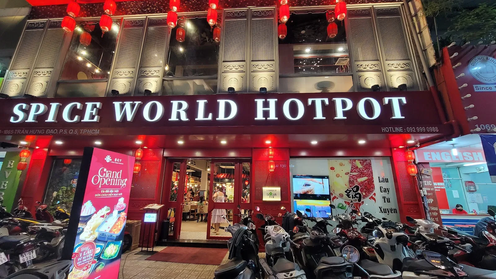 Nighttime illuminated facade of Spice World Hotpot restaurant