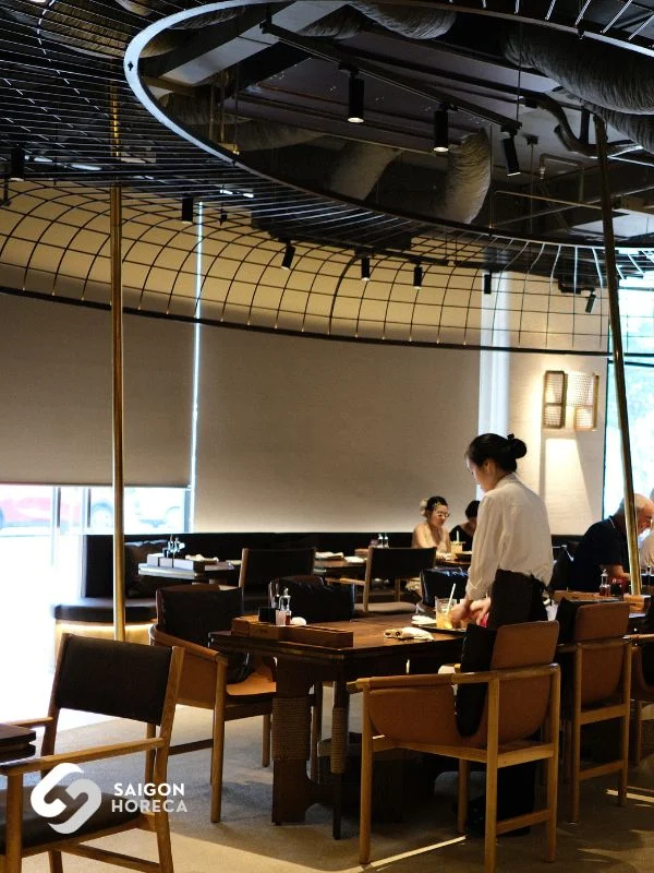 Dining tables and natural timber chairs in contemporary Mekong aesthetic