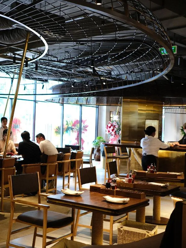 Dark wood seating and central bar at The Cheezy Time