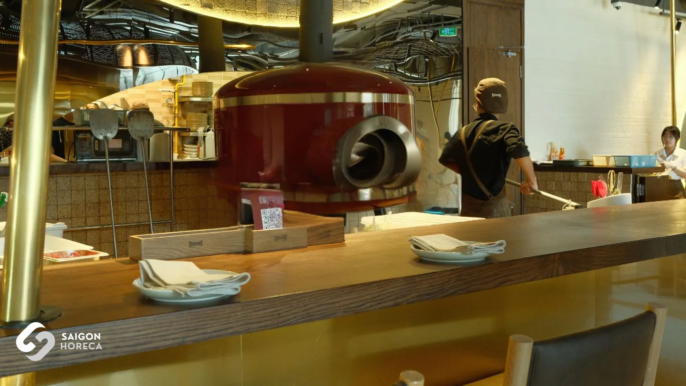 Red glazed dome pizza oven at The Cheezy Time open kitchen counter