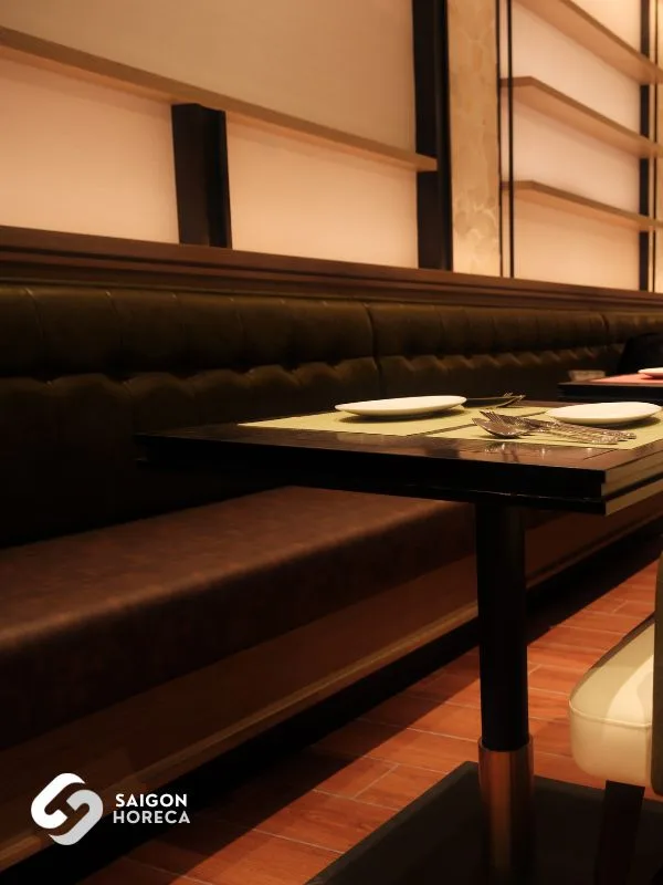 Dark wood dining tables paired with warm leather dining chairs in European salon style