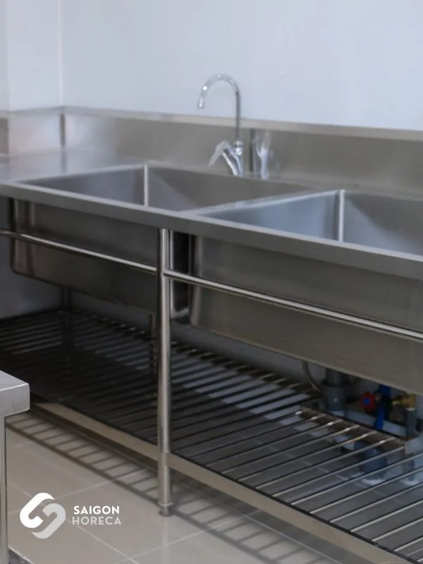 Stainless steel double prep sink with gooseneck faucet in the pre-processing area at Trinh Vuong School