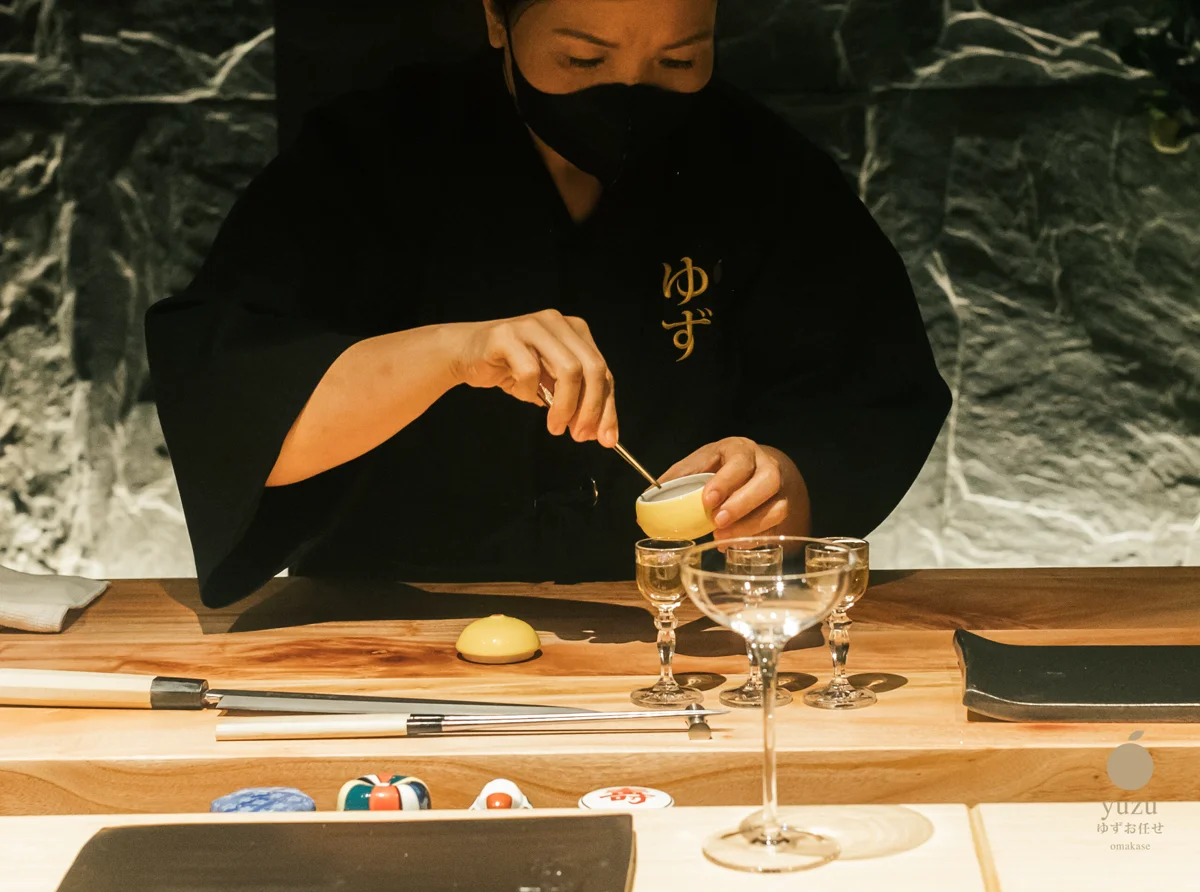 Fresh Yuzu citrus infusion ritual presented in golden fruit pottery paired with bespoke crystal stemware
