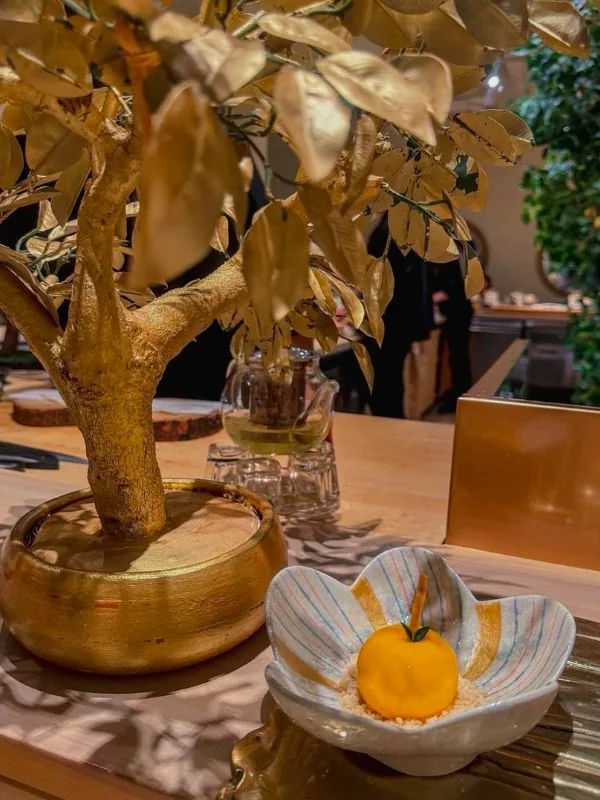 Serene Zen tea appreciation corner punctuated by an artisan gilded bonsai accent
